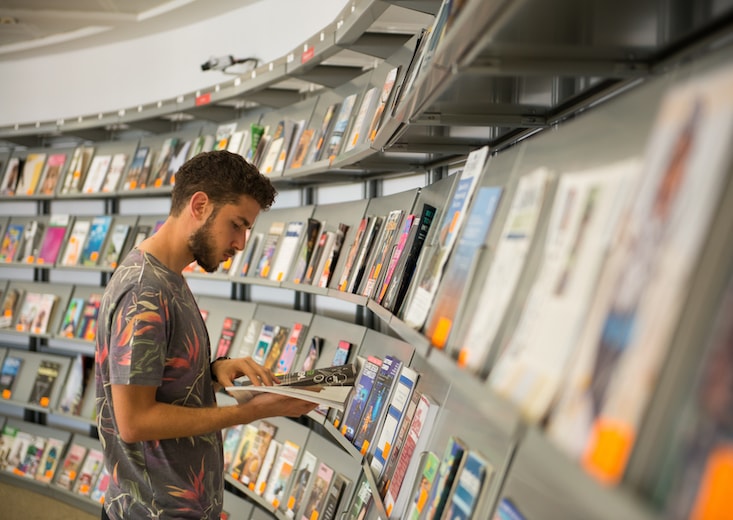 man at magazine rack